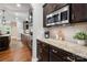 Modern kitchen featuring dark wood cabinetry, granite countertops, and stainless steel appliances at 1805 Trading Path Ln, Waxhaw, NC 28173
