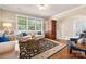 Inviting living room featuring hardwood floors, custom furniture, and lots of natural light at 1805 Trading Path Ln, Waxhaw, NC 28173