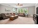 This living room features large windows, a ceiling fan, and comfortable seating at 1805 Trading Path Ln, Waxhaw, NC 28173