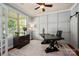 Stylish home office with custom wall paneling, natural light, and modern furnishings at 1805 Trading Path Ln, Waxhaw, NC 28173