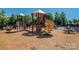 Community playground with slides and play structure in mulched area at 1805 Trading Path Ln, Waxhaw, NC 28173