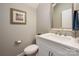 This powder room offers a clean, minimalist design with white fixtures and modern accents at 1805 Trading Path Ln, Waxhaw, NC 28173
