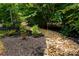 Landscaped yard with mulch and stones adding a nice touch at 1805 Trading Path Ln, Waxhaw, NC 28173