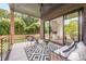 A covered porch with outdoor furniture looks into the home's interior at 1830 Commodore St, Charlotte, NC 28205