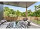Covered porch boasts stylish furniture, a ceiling fan, and an open view at 1830 Commodore St, Charlotte, NC 28205