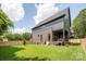 This backyard features beautiful grass and a home with modern architecture at 1830 Commodore St, Charlotte, NC 28205