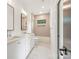 Well-lit bathroom with double vanity, modern fixtures, and a combined tub and shower at 1830 Commodore St, Charlotte, NC 28205