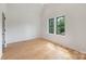 Bright, minimalist bedroom with hardwood floors and lots of natural light at 1830 Commodore St, Charlotte, NC 28205