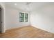 This bright bedroom features hardwood floors and large windows at 1830 Commodore St, Charlotte, NC 28205