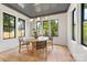 Dining room featuring a decorative ceiling, natural lighting, and view of the outdoors through black grid windows at 1830 Commodore St, Charlotte, NC 28205
