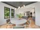 Bright dining room with view of kitchen boasts a decorative ceiling, modern light fixture, and multiple windows at 1830 Commodore St, Charlotte, NC 28205
