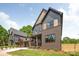 Beautiful home featuring brick and gray siding, complemented by a well-manicured lawn at 1830 Commodore St, Charlotte, NC 28205
