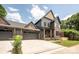 A well-manicured two-story home with a charming gray exterior, brick accents, and a spacious driveway at 1830 Commodore St, Charlotte, NC 28205
