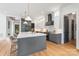 This kitchen boasts a large center island, stainless appliances, light wood floors and a modern design at 1830 Commodore St, Charlotte, NC 28205