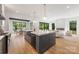 Open-concept kitchen boasts an island with quartz countertops, stainless steel appliances, and seamless flow to living area at 1830 Commodore St, Charlotte, NC 28205