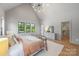 Bright main bedroom with vaulted ceiling, view of walk-in closet, and neutral decor at 1830 Commodore St, Charlotte, NC 28205