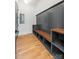 Bright mudroom features custom storage cubbies, wood bench, and gold-tone hooks at 1830 Commodore St, Charlotte, NC 28205