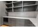 Pantry features gray cabinetry and quartz countertops and white subway tile backsplash with electrical outlets at 1830 Commodore St, Charlotte, NC 28205