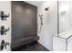 Walk-in shower featuring herringbone tile, rainfall shower head, and built-in bench at 1830 Commodore St, Charlotte, NC 28205