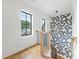 Open staircase features custom wallpaper, wood railings, and black metal balusters at 1830 Commodore St, Charlotte, NC 28205