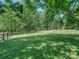 Expansive backyard with mature trees, offering privacy and ample space for outdoor activities at 202 Walden Ln, Weddington, NC 28104