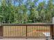 Deck view overlooking a lush, wooded backyard with professionally installed erosion control at 202 Walden Ln, Weddington, NC 28104