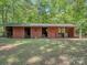 Exterior view of a well-maintained barn with multiple stalls and a rustic charm at 202 Walden Ln, Weddington, NC 28104