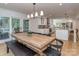 Open dining area with view of the kitchen and access to screened porch at 202 Walden Ln, Weddington, NC 28104
