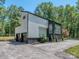 Modern home exterior with corrugated siding, black trim, and a two-car garage at 202 Walden Ln, Weddington, NC 28104