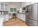 Bright kitchen features custom cabinets, stainless steel appliances and granite countertops at 202 Walden Ln, Weddington, NC 28104