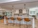 Bright kitchen with large island, granite countertops, pendant lighting, and stainless steel appliances at 202 Walden Ln, Weddington, NC 28104