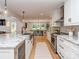 This spacious kitchen features an island, stainless appliances, and views of the dining room at 202 Walden Ln, Weddington, NC 28104