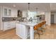 Bright kitchen with large island, granite countertops, stainless steel appliances, and hardwood floors at 202 Walden Ln, Weddington, NC 28104