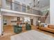 Spacious open-concept layout showcasing living area, kitchen, and upper-level loft with balcony at 202 Walden Ln, Weddington, NC 28104