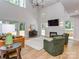 Open living room with vaulted ceilings, hardwood floors, fireplace, and access to outdoor spaces at 202 Walden Ln, Weddington, NC 28104