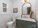 Stylish powder room with marble countertop, modern fixtures, and elegant decor at 202 Walden Ln, Weddington, NC 28104