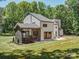 Back exterior featuring a screened porch, patio, and spacious yard, perfect for outdoor activities at 202 Walden Ln, Weddington, NC 28104