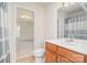 Bathroom with wood vanity and a view into the bedroom at 2100 Goddard Way, Waxhaw, NC 28173