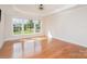Bedroom with a tray ceiling, large windows offering plenty of natural light, and hardwood floors at 2100 Goddard Way, Waxhaw, NC 28173
