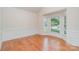 Bright dining room with hardwood floors, wainscoting, large bay window with decorative trim, and neighborhood views at 2100 Goddard Way, Waxhaw, NC 28173