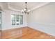 Classic dining room featuring hardwood floors, a decorative ceiling, and a large window with plenty of light at 2100 Goddard Way, Waxhaw, NC 28173