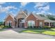 Beautiful brick home with an elegant entryway, manicured lawn, and professional landscaping at 2100 Goddard Way, Waxhaw, NC 28173