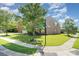 Corner lot home featuring lush grass, mature trees, and neat sidewalks on a sunny day at 2100 Goddard Way, Waxhaw, NC 28173