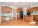 Well-lit kitchen features custom wood cabinets, granite countertops, and an island for efficient work space at 2100 Goddard Way, Waxhaw, NC 28173