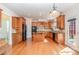 Stylish kitchen with an island, wooden cabinets, granite countertops, and stainless steel appliances at 2100 Goddard Way, Waxhaw, NC 28173