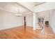 Bright, open living room features a fireplace, gleaming hardwood floors, and elegant decorative molding at 2100 Goddard Way, Waxhaw, NC 28173