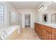 Bright main bathroom with double vanities, a soaking tub, and a glass enclosed shower at 2100 Goddard Way, Waxhaw, NC 28173
