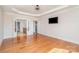 Spacious main bedroom featuring a tray ceiling, hardwood floors, and ensuite bathroom at 2100 Goddard Way, Waxhaw, NC 28173