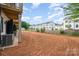 Backyard view shows the townhouse rear, newly installed A/C units, and the graded yard before landscaping is installed at 212 Mattoon St, Charlotte, NC 28216