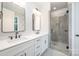 Bathroom featuring double vanity, black hardware and a glass shower with gray stone tile at 212 Mattoon St, Charlotte, NC 28216